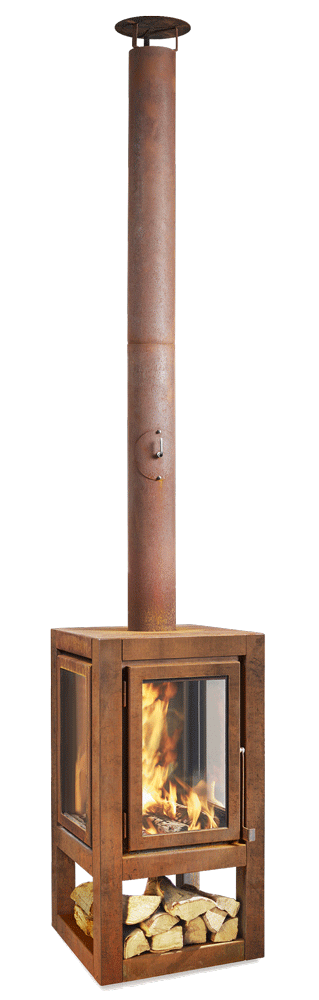 A modern cube-shaped Quaruba XXL mobile outdoor log burner made of Corten steel with visible rust. There is a fire burning inside the log burner and it's attached to a vertical chimney.