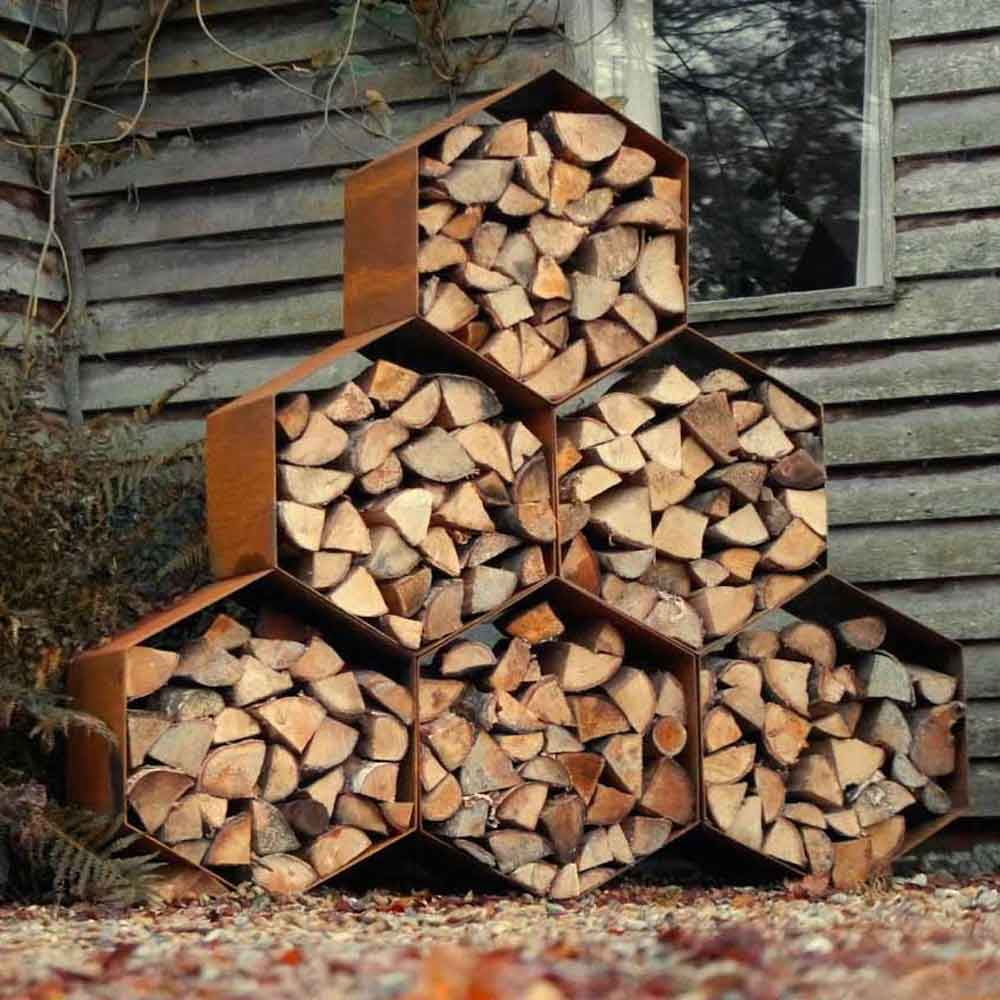 RUSTED HEXAGON CORTEN LOG WOOD STORE IN GARDEN BY PARKER AND COOP
