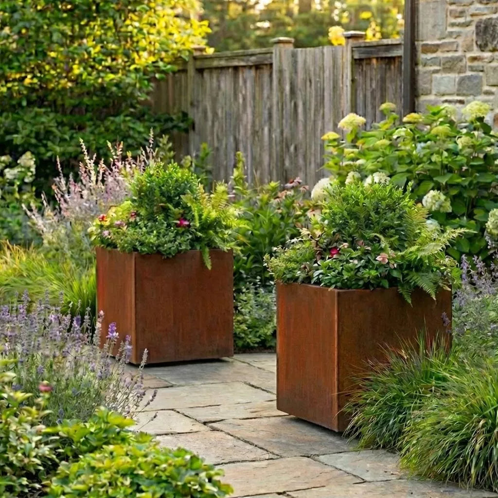 2 mobile corten steel planters on wheels with plants

