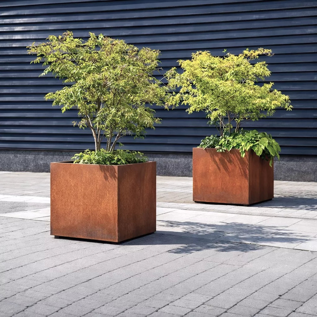 2 mobile corten steel planters on wheels with trees