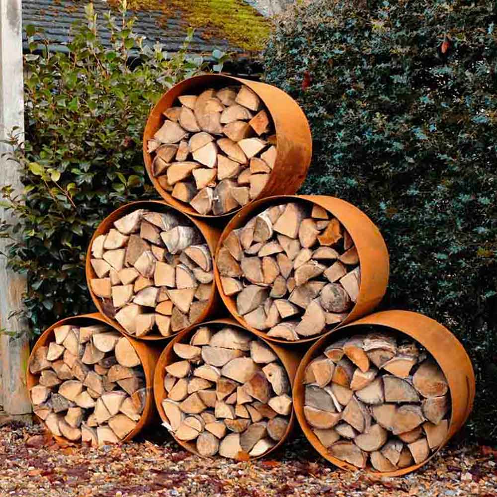 RUSTED CORTEN LOG WOOD STORE IN GARDEN BY PARKER AND COOP